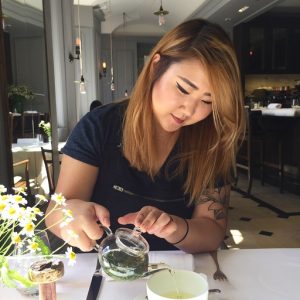 Photo of Stephanie pouring a mini glass teapot into a teacup.