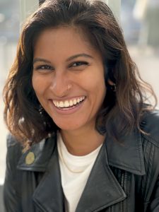 Dharani Persaud grins at the camera.